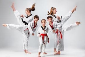An image of kids training karate martial arts on gray background.