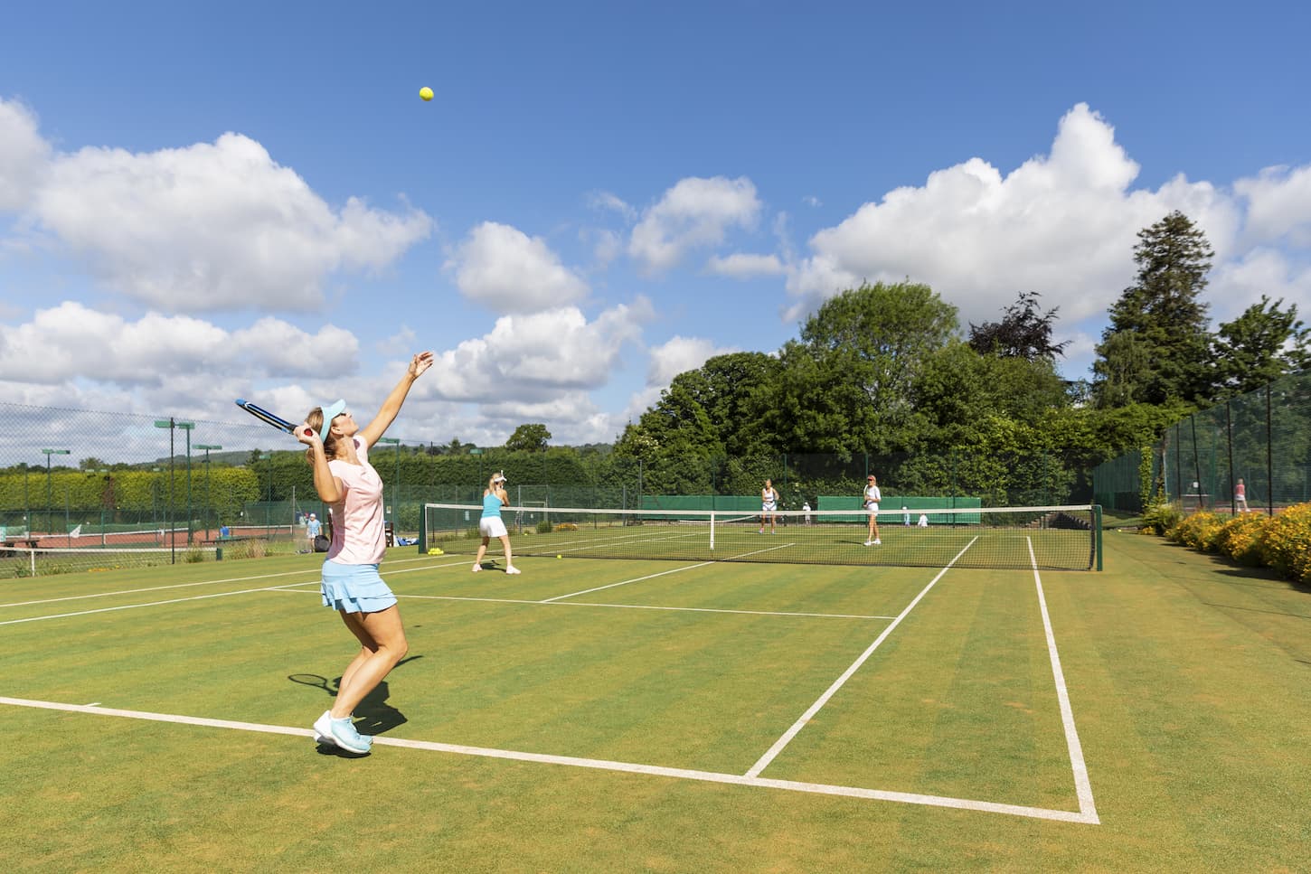 An image of Mature women during a tennis match on grass court.