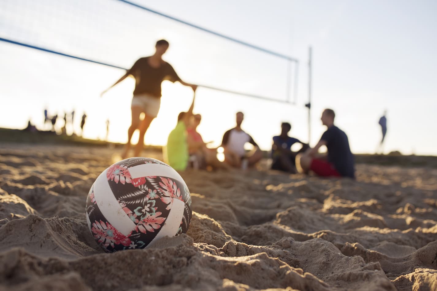 An image of a volleyball on the beach.