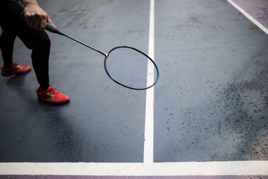 An image of a badminton court and player