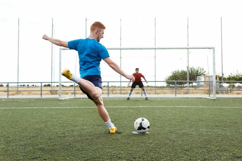 An image of a Player kicking a soccer ball.