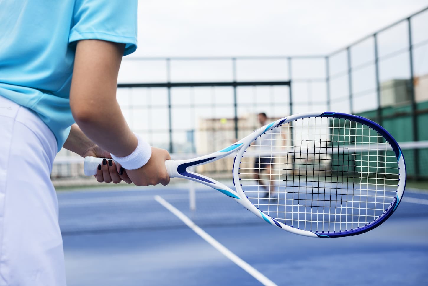 An image of Tennis players training on a court.