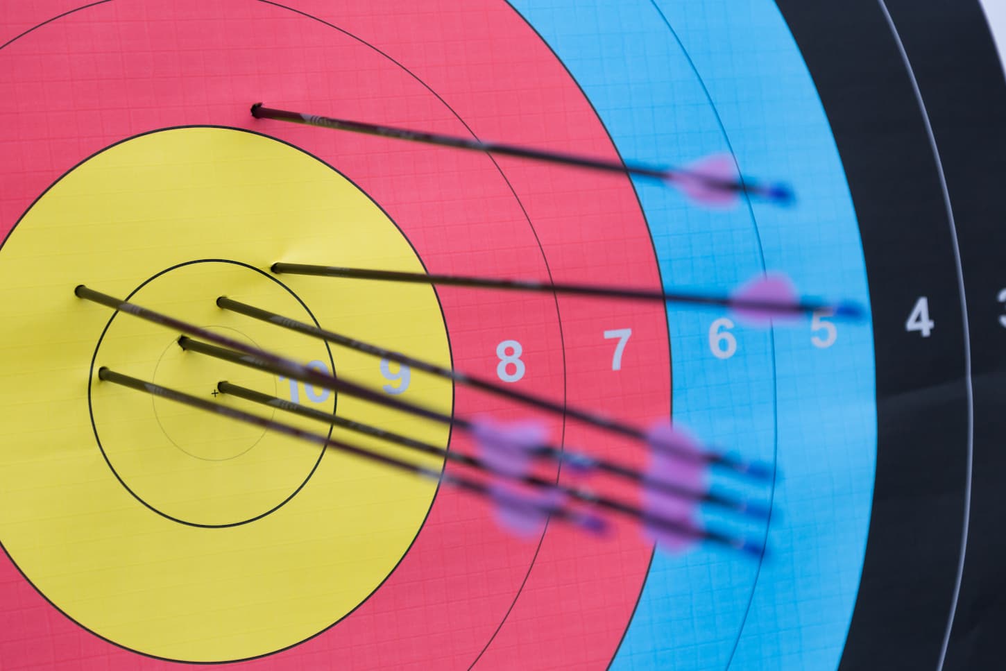 An image of Archery target with arrows on it.