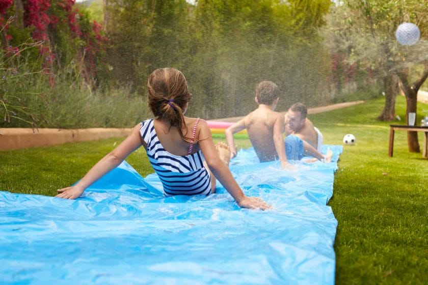 An image of a Family Having Fun On a Water Slide.