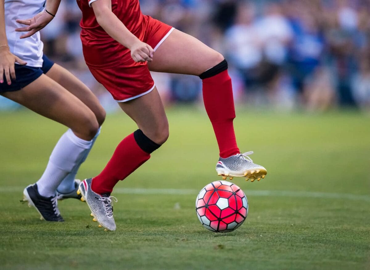 An image of a soccer Player Kicking the ball.